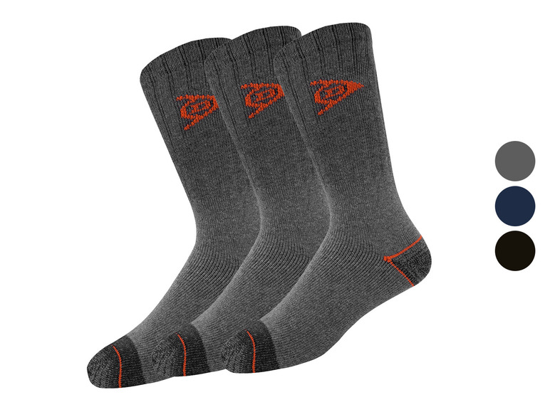 Trzy pary szarych skarpet z pomarańczowymi akcentami.