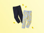 Dwie pary spodni dresowych, jedne ciemnoniebieskie, a drugie jasnoniebieskie w cytryny.