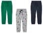 Trzy chłopięce spodnie dresowe, zielone, szare z dinozaurami i granatowe.