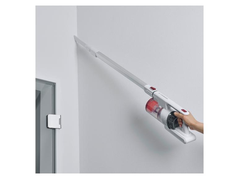 Biały odkurzacz ręczny S-Power używany do czyszczenia rogu.