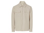 Beżowa koszula z długim rękawem i zamkiem błyskawicznym.