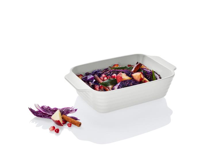 Biała forma do pieczenia z czerwoną kapustą, jabłkiem i granatem.
