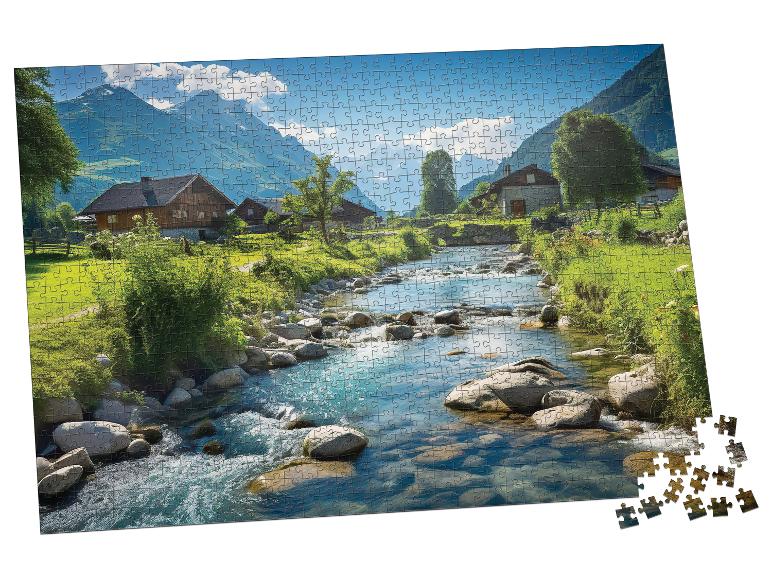 Częściowo ukończone puzzle przedstawiające górską wioskę z rzeką i domami.