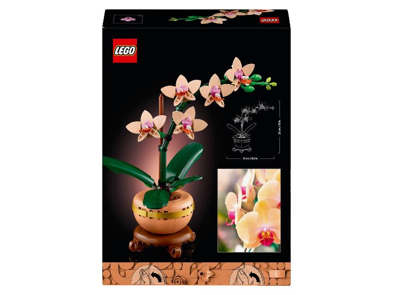 Zabawkowa orchidea w doniczce, wysoka na 25 cm i szeroka na 21 cm.