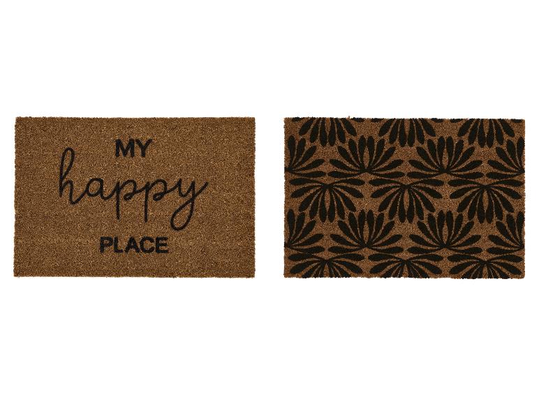 Dwie brązowe wycieraczki kokosowe, jedna z napisem „MY happy PLACE”, druga z czarnym wzorem kwiatowym.