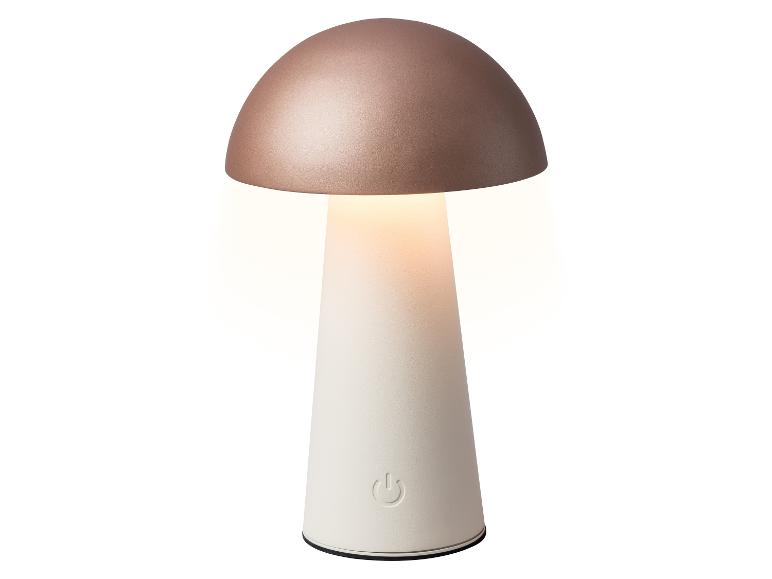 Lampa stołowa w kształcie grzyba z różowo-złotym blatem i białą podstawą, emitująca ciepłe światło.