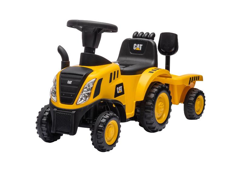 Żółty traktor-jeździk z przyczepką i łopatą, z czarnym siedzeniem i kierownicą.