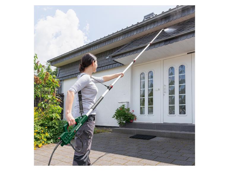 Kobieta czyści dach domu myjką ciśnieniową Parkside.