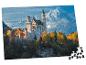 Puzzle z zamkiem Neuschwanstein i ośnieżonymi górami, z brakującymi elementami