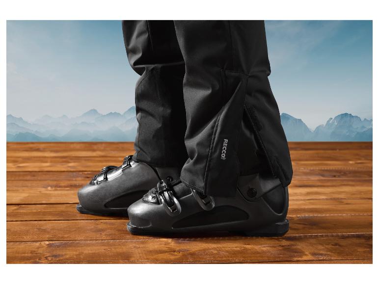 Czarne buty narciarskie z technologią Recco na tle gór.