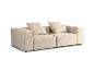 Modułowa beżowa sofa z poduszkami na białym tle.