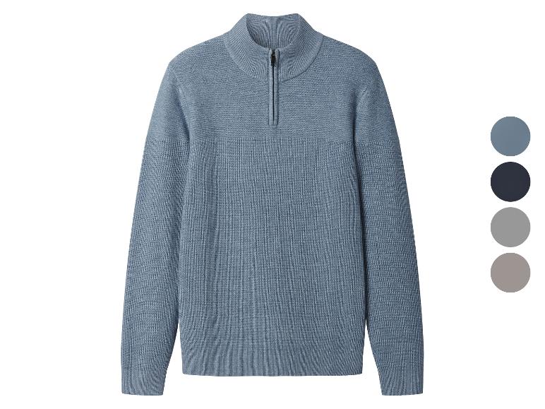 Niebieski sweter dzianinowy z krótkim zamkiem błyskawicznym i paletą kolorów.