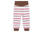 Białe spodnie w paski z różowymi i brązowymi paskami.
