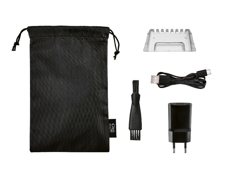 Zestaw do pielęgnacji osobistej z etui, grzebieniem, szczotką, kablem USB i zasilaczem.