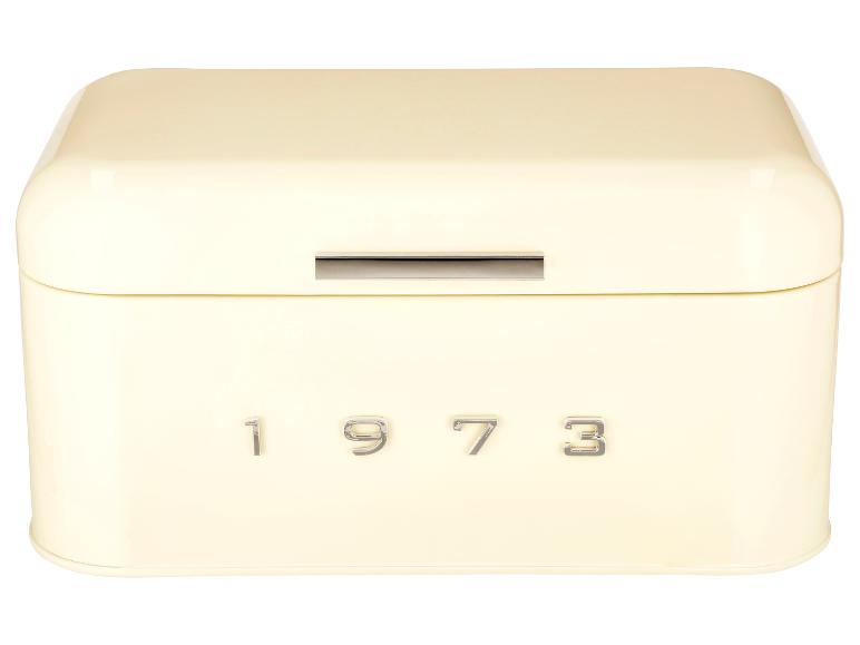 Kremowa metalowa puszka na chleb z napisem '1973'.