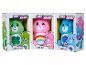 Trzy pluszowe misie Care Bears w pudełkach: Good Luck Bear, Cheer Bear i Grumpy Bear.
