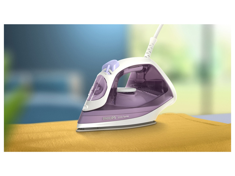 Fioletowe żelazko Philips 2000 Series na żółtej tkaninie.