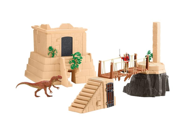 Zestaw zabawek z dinozaurem, ruinami i wiszącym mostem.