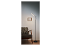 Nowoczesna lampa podłogowa LED obok fotela.