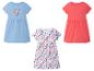 Trzy sukienki dla dziewczynek: niebieska z konikiem morskim, różowa gładka i biała w muszelki.