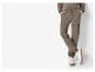 Męskie spodnie cargo i białe buty sportowe.