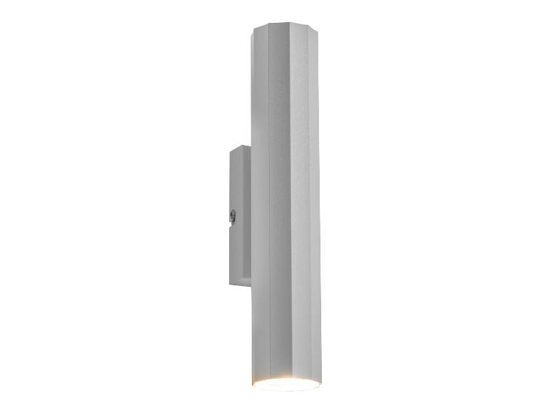 Szara, cylindryczna lampa ścienna.