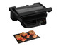 Grillowany stek na czarnej desce, nad nim Tefal OptiGrill.