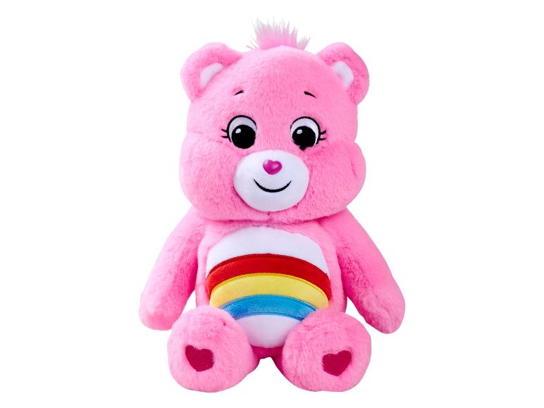 Różowy pluszowy miś Care Bear z tęczą na brzuchu.