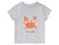 Szary t-shirt z nadrukiem kraba i napisem 'sea you later'.