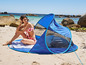 Kobieta w bikini relaksuje się pod namiotem plażowym Livarno.