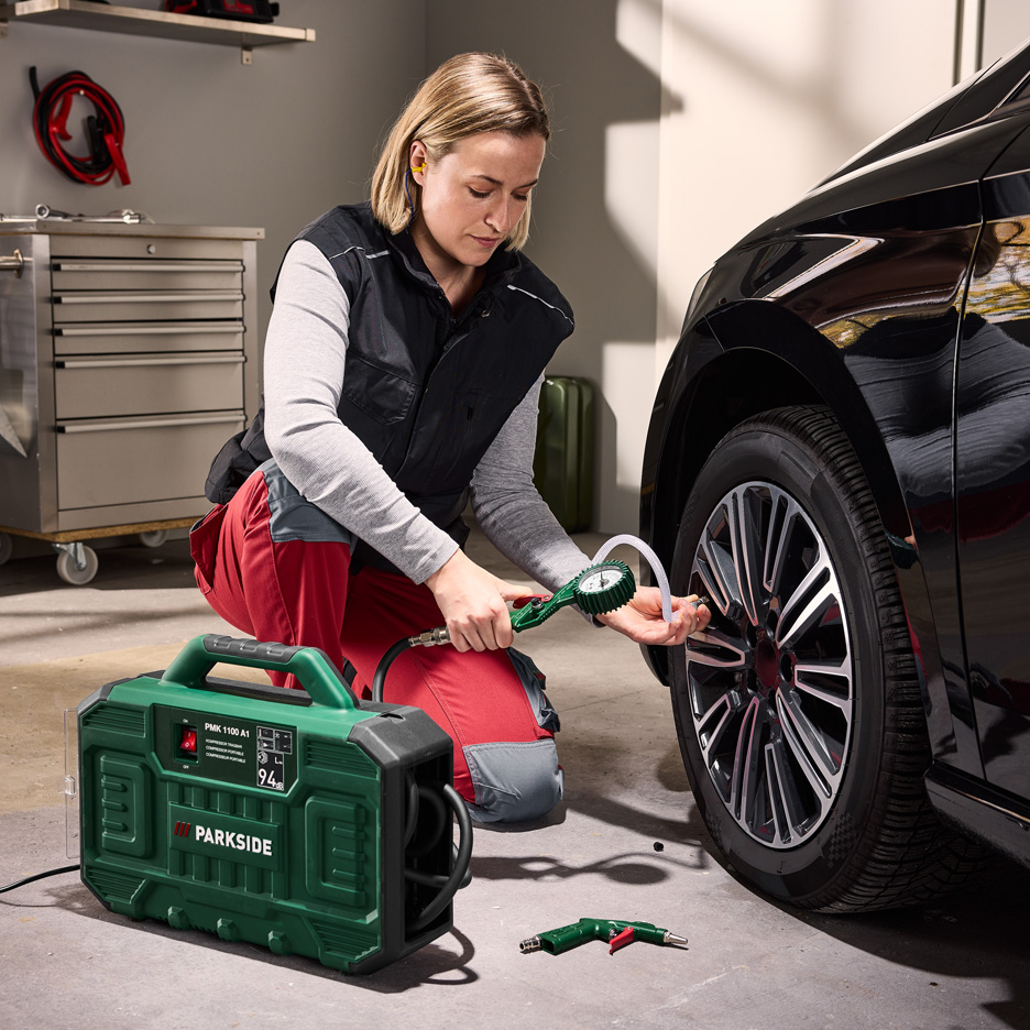 Kobieta pompuje oponę samochodową kompresorem Parkside PMK 1100 A1.